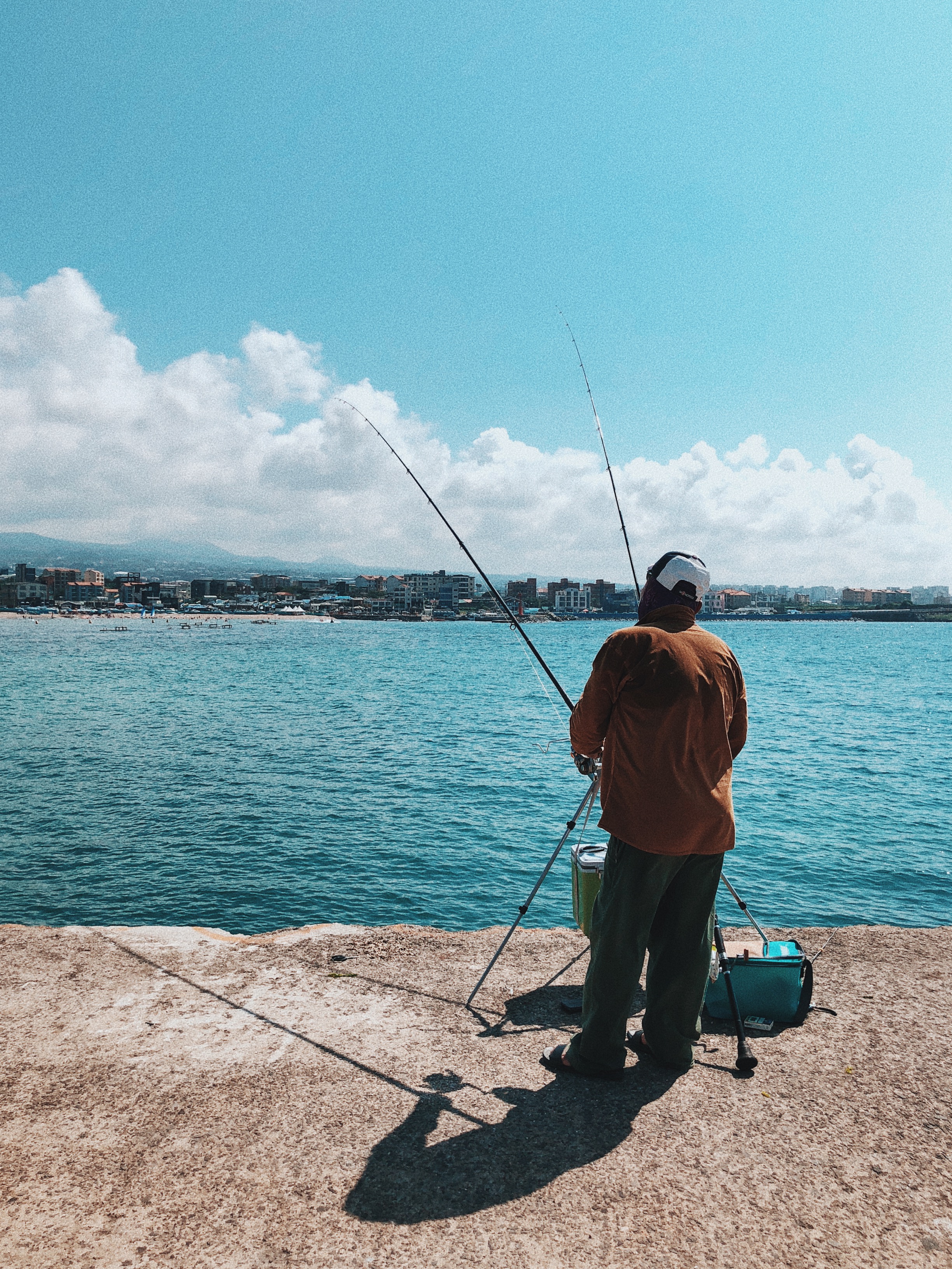 Man fishing alone during summer at Iho Tewoo Beach Jeju